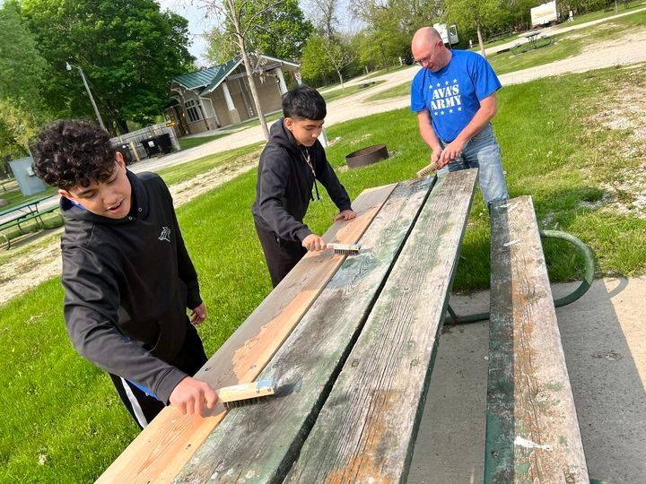 Volunteers re-painting benches
